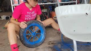 The girl repaired and restored an old wheelbarrow to work again