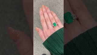 Take a look at this stunning green emerald trilogy engagement ring