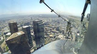 Riding down the OUE Skyspace LA Skyslide 1,000 feet above ground.