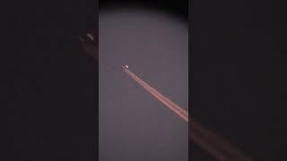 plane flies in front of moon