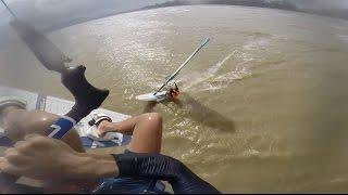 Kitesurfer jumps over a windsurfer