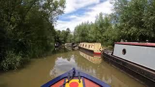 Navigating on the Oxford canal through Thrupp in a narrow boat.