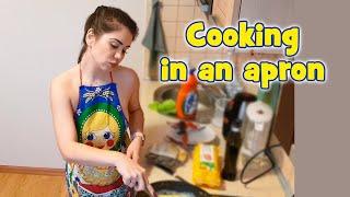 Cooking chicken and eggs in an apron