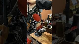 Print making with a large linocut with a tabletop printing press