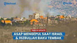 Asap mengepul saat Israel dan Hizbullah saling baku tembak di perbatasan Lebanon.