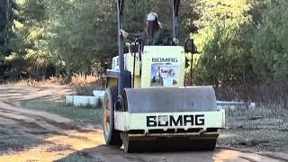 Making a new road to my wood yard.   BOMAG in action, makes such a big difference.