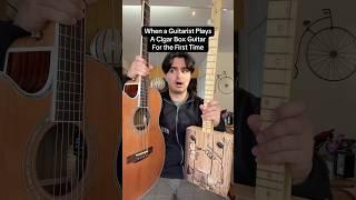 When a guitarists plays a cigar box guitar for the first time