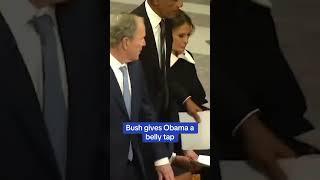 Bush gives Obama a belly tap