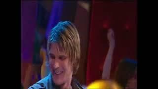 Basshunter dancing in a circle of children