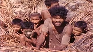 Natives group together in a foxhole in Eniwetok Atoll, Marshall Islands during Wo...HD Stock Footage