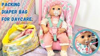 Baby Annabell Doll packing diaper bag, feeding, and changing diaper