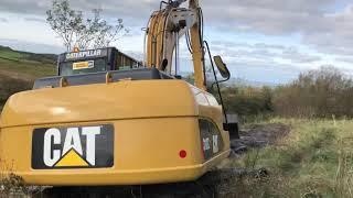 CAT 312C Excavator clearing out a swamp