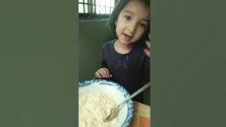 Cute little girl showing her cooking skills.