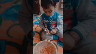 cute baby cutting carrots 