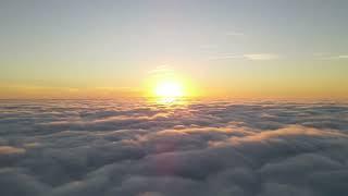 Drone time lapse video of sunrise above the fog