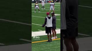 Ja’Marr Chase and Tee Higgins chat on the sideline as observers at Thursday’s practice