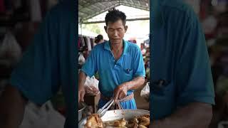 a man cooking fried chicken