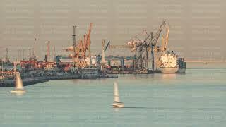 Container cargo ship during docking at industrial port with cranes aerial timelapse. Lisbon