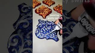 Painting pretty scrolls and swirls on personalized sparkly epoxy resin ornaments