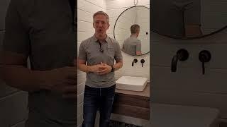 This tiny bathroom utilizes extra space in a garage loft, creating a unique and functional feature!