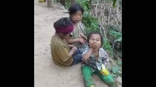 poor family in village. do you know these kids. Three kids waiting father cooking building meals