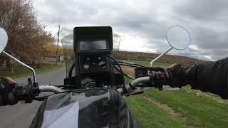 Suzuki DR650 on covered wooden bridge in fall