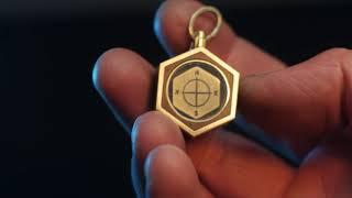 The process of making a pendant or keychain in the form of a compass