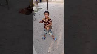 6 year old boy playing drum TAJIKISTAN