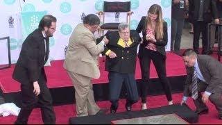 JERRY LEWIS supported by staffers when legs almost fail him