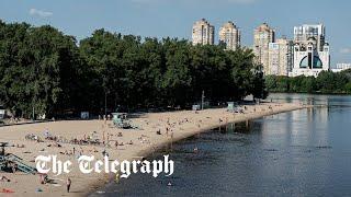 Ukrainians enjoy peaceful beach weather in Kyiv as war rages on eastern fronts