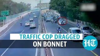 Watch: Delhi traffic policeman dragged on bonnet of a car