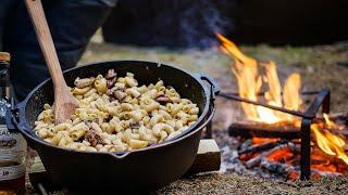 Outdoor cooking in the forest - Petromax dutch oven campfire casserole with whisky