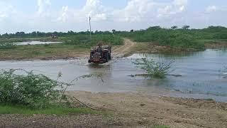 power di tractor in river