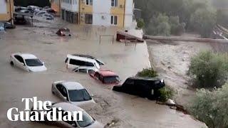 Cars float through residential street in southern Russia following flash floods