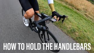 How to hold the road bike handlebars for power and stability