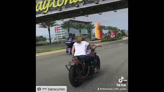 Biker girl cruising into Daytona on vintage Harley-Davidson motorcycle