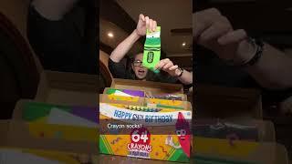 Opening a gift from Crayola