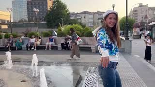 in a summer fountain in jeans