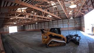 Regrading and repairing the base of an indoor arena with Cat 289d3 and gb124 grader attachment.