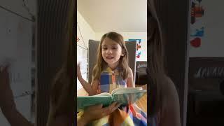 She is smart little girl is reading a book