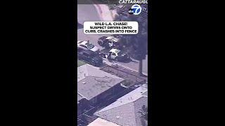 Wild LA chase! Suspect drives onto curb, crashes into fence