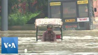 Rickshaw Driver Pedals Through Flooded Indian Street | VOA News