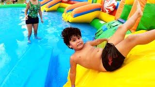 Kai and Clara Play at Water Park and Inflatable Toys. Kai The King of Water Slides