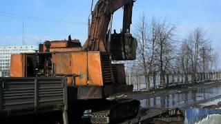 Old soviet excavator EO-4124 loadin" on a trailer