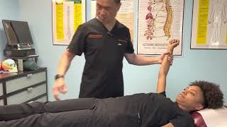 BLACK BELT CHIROPACTOR using Applied Kinesiology Technique to adjust a patient.