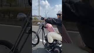 Biker girl kick starting classic Harley-Davidson motorcycle