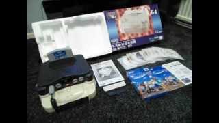 An NTSC N64 with boxed Doctor V64 disc drive