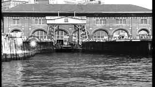 A ferry boat enters the slip between two piers on New York Bay. HD Stock Footage