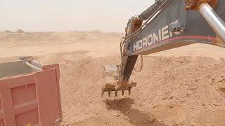 Hidromek loading soil on trucks