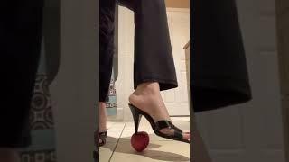 Sexy heels crush apple in slow motion